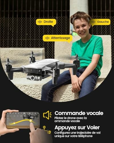 Boy sitting and controlling a drone with a smartphone app using voice commands.