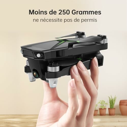 Hand holding a compact drone, less than 250 grams, no permit required.