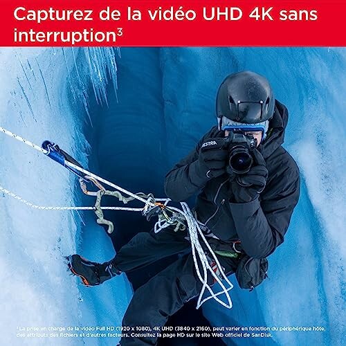 Ice climber capturing video in crevasse